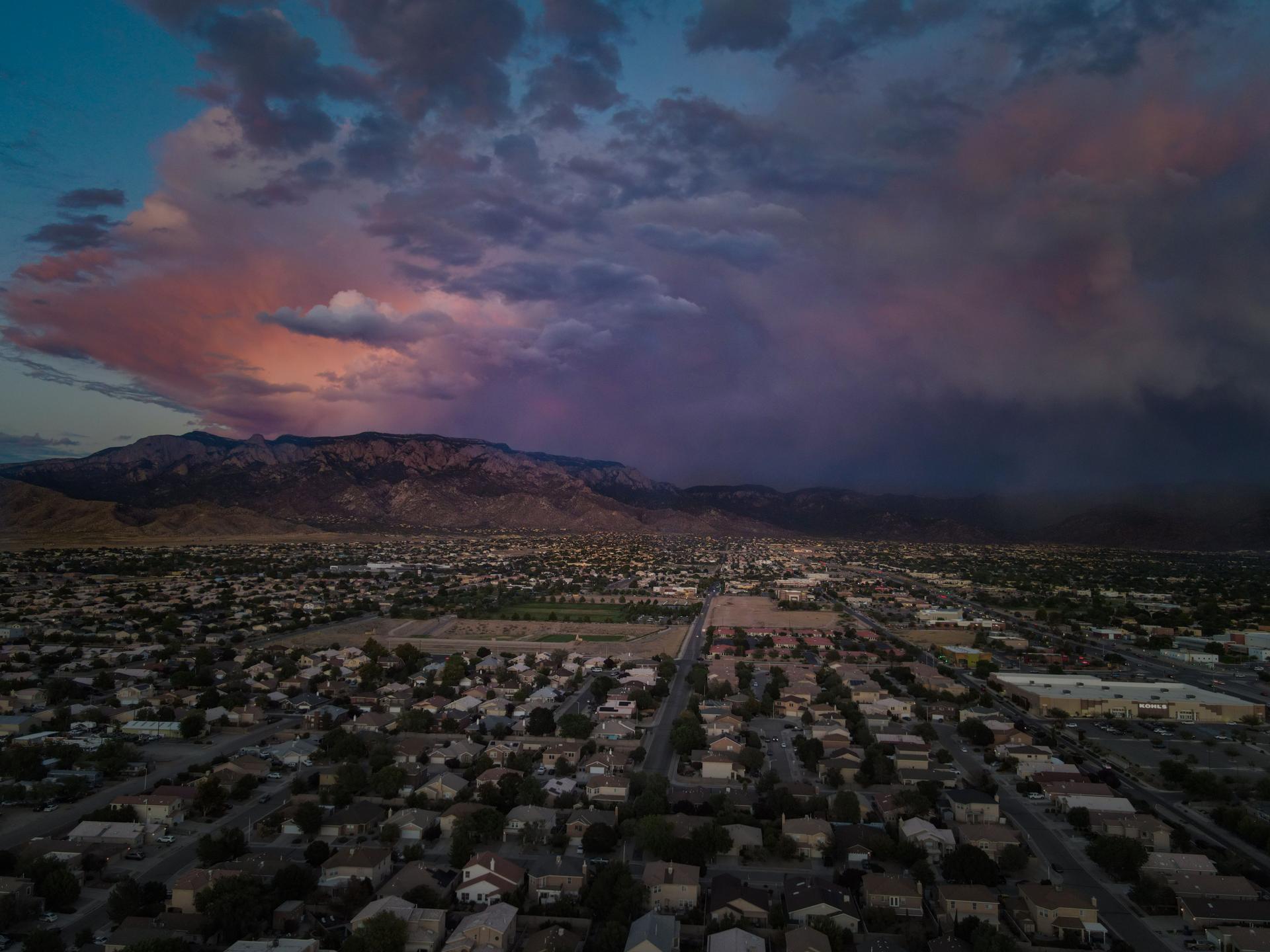 stormy sunset mountains city